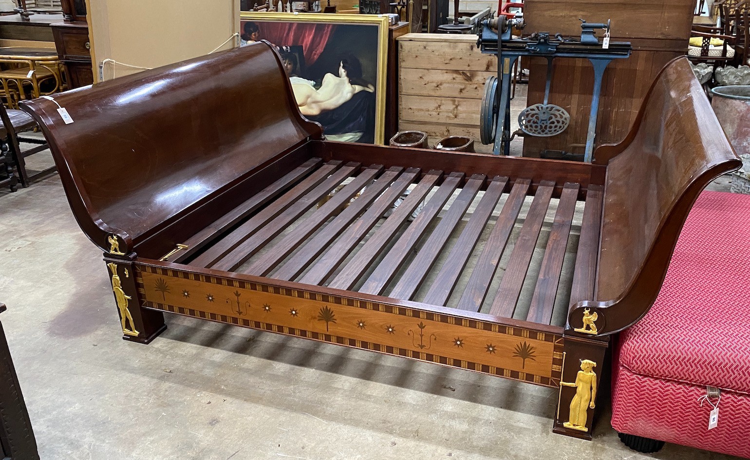 A reproduction Egyptian style inlaid gilt metal mounted mahogany sleigh bedframe, width 193cm, length 261cm, height 110cm